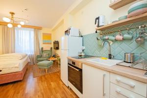 a kitchen with a sink and a room with a bed at Cozy Lodge Kopaonik in Kopaonik