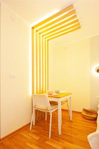 a dining room with a table and a chair at Cozy Lodge Kopaonik in Kopaonik +6 photos