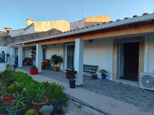 a house with a patio with potted plants on it at Casa Madureira in Alpalhão
