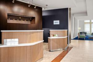a lobby with a counter and a waiting room at Courtyard by Marriott Evansville East in Evansville +21 photos