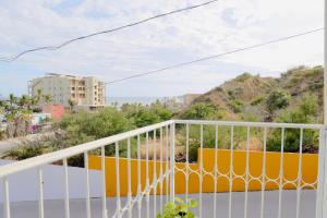 a balcony with a white railing and a view of a city at Estudio con vista al mar in San José del Cabo