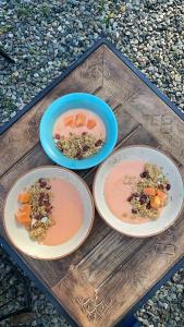 three plates of food on a wooden table at Bell Glamping by The HULYA since 2021 in Mukteshwar +31 photos