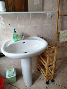 a bathroom with a white sink in a room at OLMETA DI TUDA - T3 in Olmeta-di-Tuda