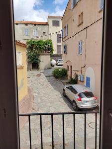 a view from a window of a street with a car at OLMETA DI TUDA - T3 in Olmeta-di-Tuda