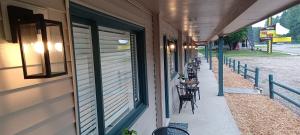 a row of tables and chairs on the side of a building at TeePee Room 5- Newly Renovated in Roscommon