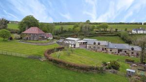 an aerial view of a large house in a field at Smiddy Cottage, Historic Village Hub with Spacious Lounge, High Ceilings, and Wood Stove in Dulverton +16 photos