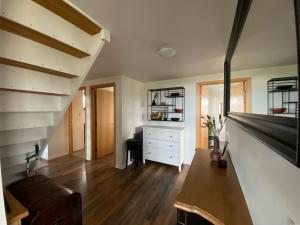 a living room with a couch and a staircase at Myrarkot Country Home in Selfoss