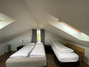 two beds in a room with a attic at Myrarkot Country Home in Selfoss