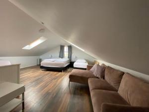 a living room with a couch and a bed at Myrarkot Country Home in Selfoss