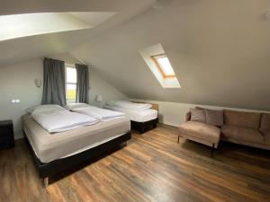 a room with two beds and a couch in it at Myrarkot Country Home in Selfoss