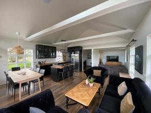 a living room with a couch and a table at Myrarkot Country Home in Selfoss