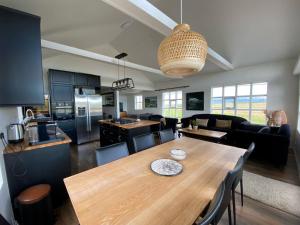 a kitchen and living room with a wooden dining table at Myrarkot Country Home in Selfoss
