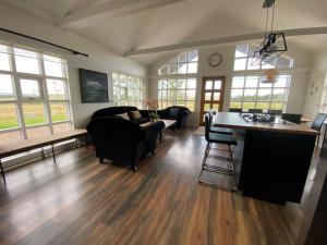 a living room with couches and a table at Myrarkot Country Home in Selfoss