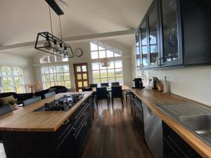 a kitchen with a counter with a stove top oven at Myrarkot Country Home in Selfoss