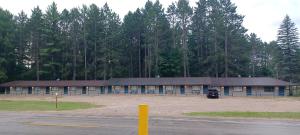 a building with a lot of windows in front of trees at TeePee Room 4 - Newly Renovated in Roscommon +12 photos