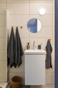 a bathroom with a white sink and a mirror at Dotan's Boutique Studios - By Gordon Beach! in Tel Aviv