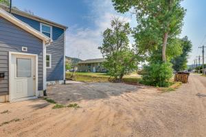 a dirt road next to a house with a garage at Cozy Sturgis Retreat - Walk to Main St and Saloons! in Sturgis