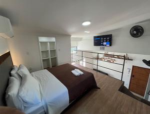 a bedroom with a bed and a clock on the wall at Pousadas Ribeiro in Vila Velha