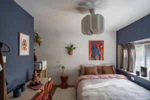 a bedroom with blue and white walls and a bed at Dotan's Boutique Studios - By Gordon Beach! in Tel Aviv
