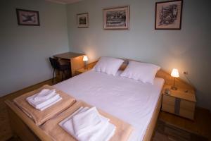 a bedroom with a large white bed with two pillows at Apartment VI&MI in Slunj
