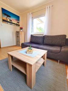 a living room with a couch and a coffee table at Ferienwohnung-Anna in Fischbach bei Dahn