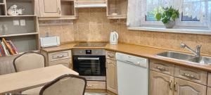 a small kitchen with a sink and a stove at Noclegi Lebiedziew in Terespol