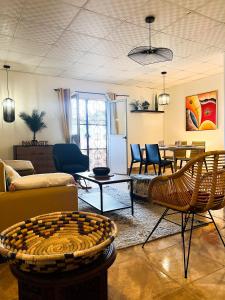 a living room with a couch and chairs and a table at Tropicalme Pamandzi in Pamandzi