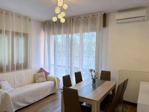 a living room with a couch and a table at Last Minute Booking in Peschiera del Garda +55 photos