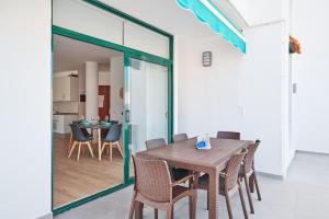 a dining room with a wooden table and chairs at EDEN RENTALS Marine Rest Cove in Puerto de Santiago