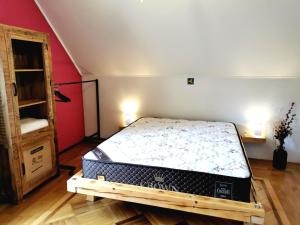 a bedroom with a bed in the corner of a room at Apartmaji ARKO in Ribnica