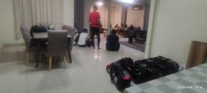 a man standing in a room with a group of people at HOMESTAY ALORSETAR TOWNCENTRE by ASTARILA GUESTHOUSE-AmanCentral -iSLAM SAHAJA - 2storey Banglo, Private Pool, BBQ area & sports - max 30pax in Alor Setar +39 photos