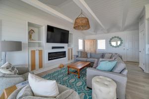 a living room with two couches and a tv at Oceanfront - Pool - Luxury North Topsail Beach House in West Onslow Beach +43 photos