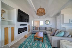 a living room with a couch and a tv at Oceanfront - Pool - Luxury North Topsail Beach House in West Onslow Beach