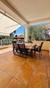 a patio with a table and chairs on a patio at Apartmani Alenka in Šibenik
