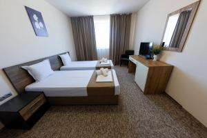 a hotel room with two beds and a desk at City Plaza in Botevgrad +68 photos