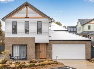 a white house with a white garage at New Central 2 bedroom townhouse in Beechworth