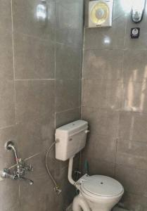 a bathroom with a white toilet in a room at Bell Glamping by The HULYA since 2021 in Mukteshwar