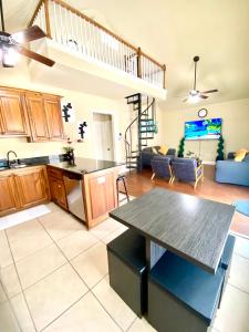 a kitchen and living room with a table and a couch at Grand Isle Unit E pet friendly detached condo 3 bedrooms 1 bath easy beach access in Grand Isle
