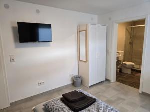 Elle comprend un lit et une salle de bains pourvue d'une télévision murale. dans l'établissement Übernachtung by Tag, à Cassel 67 autres photos