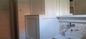 a kitchen with a white cabinet and a sink at Apartmán Siná in Lazisko