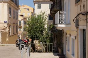 a motorcycle parked in an alley between buildings at Celestial Suites-TOP LOCATION in Corfu Town
