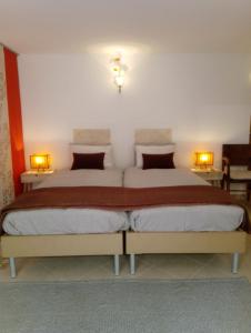 a bedroom with two beds and two lights on the wall at Manta Rota Beach, apartment in a villa, terrace,garden in Manta Rota