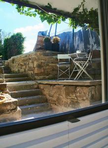 a stone stairs with a table and a chair at Gemütliche Wohnung Rothaarsteig Ski Sauna Ruhrtal Green Hill in Schmallenberg