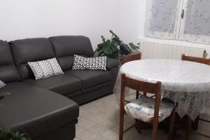 a living room with a black couch and a table at Centralissimo Mi.Ma in Milano Marittima