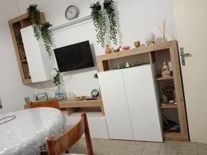 a living room with a desk and a white cabinet at Centralissimo Mi.Ma in Milano Marittima