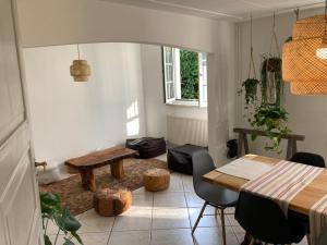 a room with a table and a table and chairs at Maison avec piscine privée au calme in Schlierbach