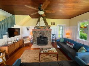 a living room with a blue couch and a fireplace at Waterfront Cottages in Lexington Vacation Homes in Lexington