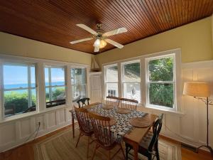 a dining room with a table and chairs and windows at Waterfront Cottages in Lexington Vacation Homes in Lexington