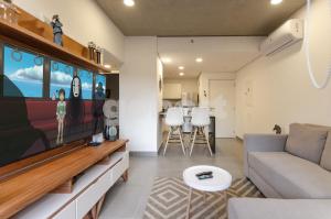 a living room with a couch and a flat screen tv at Distinguished And Elegant Apartment 2 Bedroom in Asuncion