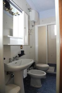 a bathroom with a sink and a toilet at Residence Il Sole in Follonica